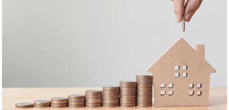 Coins and a house model